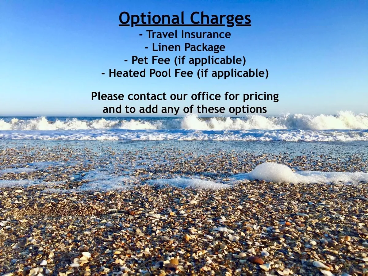 A serene stretch of sandy beach meets gentle ocean waves under a clear blue sky. The beach is wide and inviting, perfect for swimming, sandcastle building, and family games. The scene captures the essence of classic beach adventures just steps from the property.